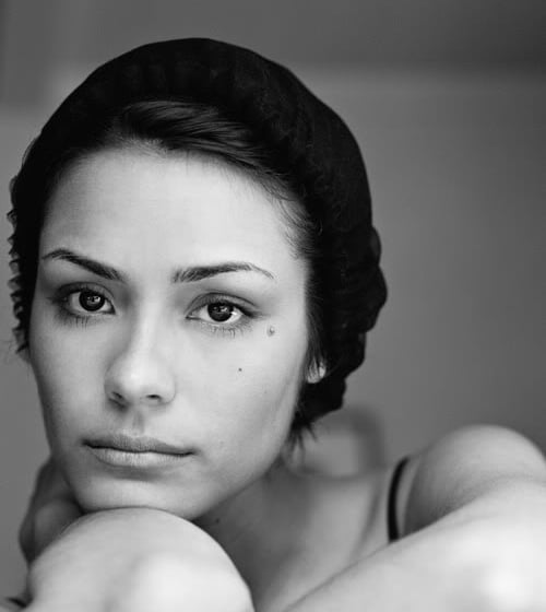 A woman looking into the camera in greyscale